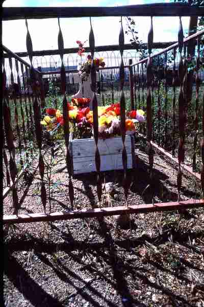 Grave with surrounding fence. - [Fond du Lac, Sask.].