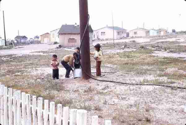 Children at water hoses. 8/71